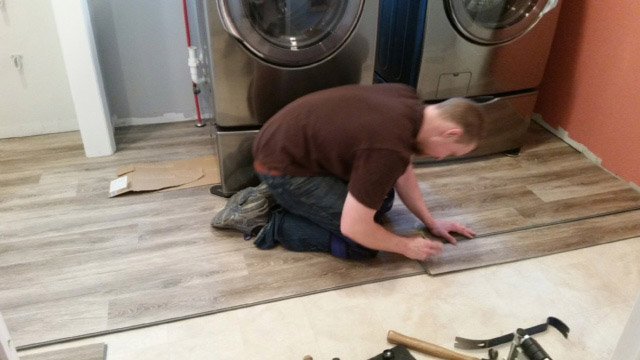 person installing laminate flooring