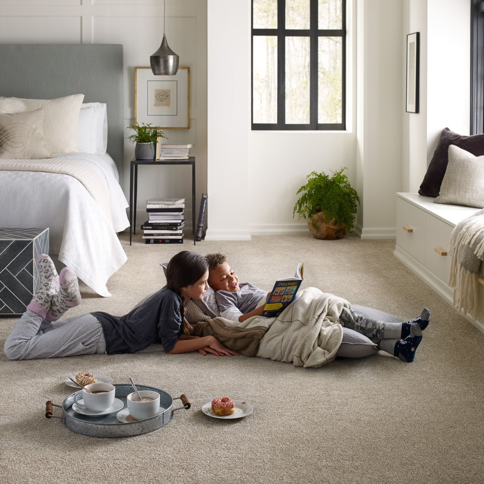 kids reading on bedroom floor from McMillen's Carpet Outlet in Clarion