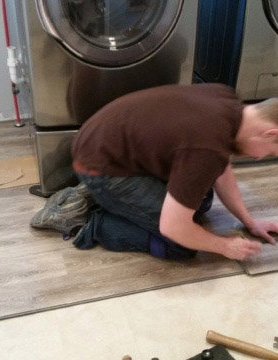 person installing laminate flooring